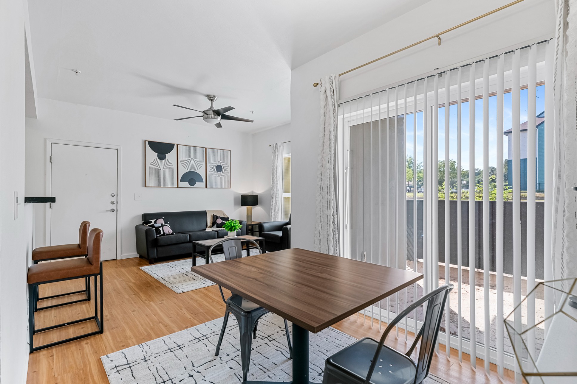 Green Spring Apartments near TXST furnished dining space and living room with private patio