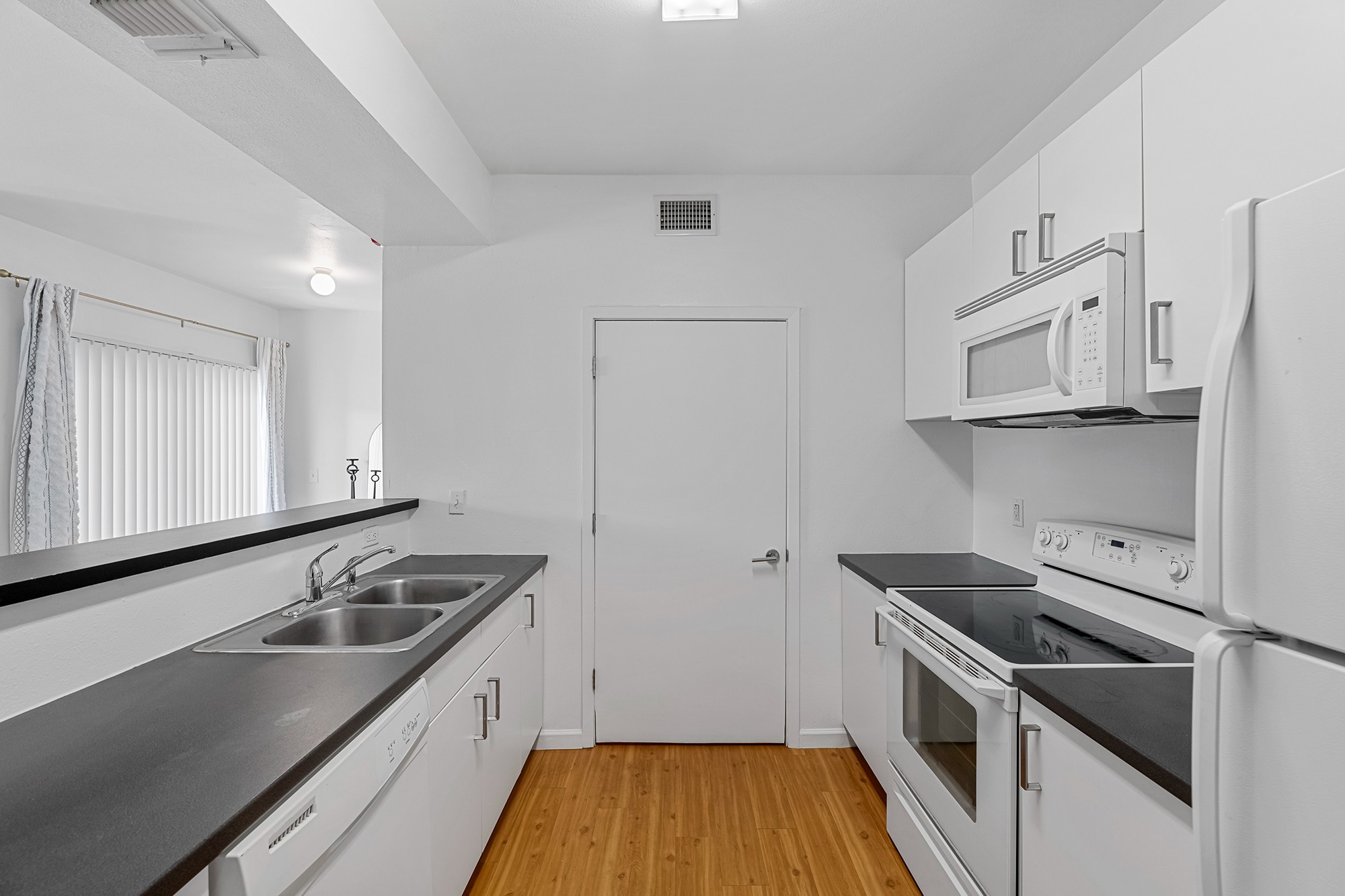 Green Spring Apartments near TXST kitchen with hardwood style flooring