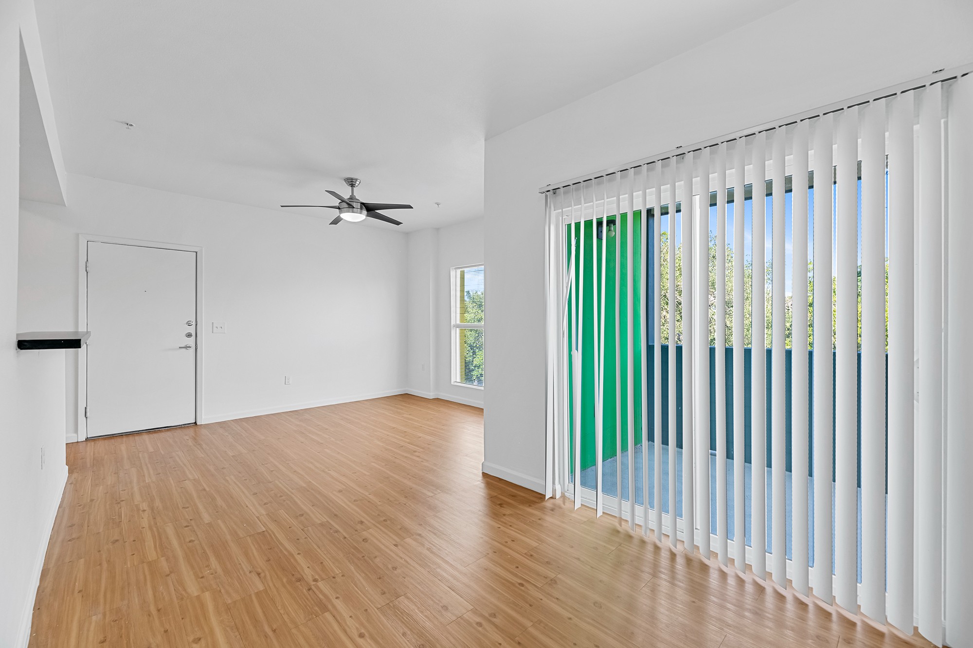 Green Spring Apartments near TXST unfurnished living room, common area, and private patio